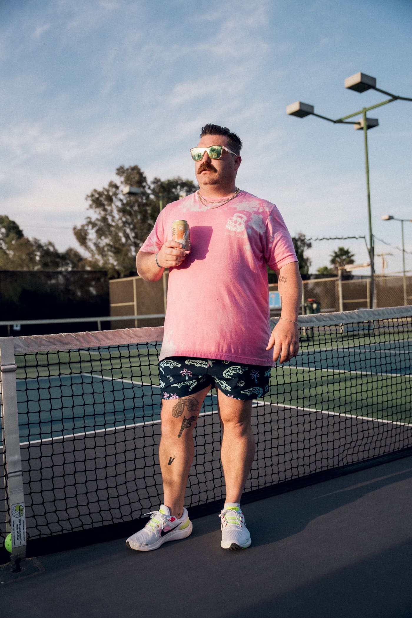 Pickleball serve, pink tie-dye, golden hour.