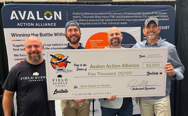 Four men holding an oversized five thousand dollar donation check to Avalon Action Alliance